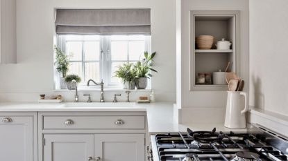 A white kitchen with a gas stove and alcove organization