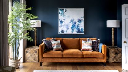 A living room with brown sofa idea with dark blue walls and brown ochre sofa