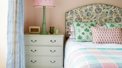 bedroom with patterned headboard, bed and chest of drawers